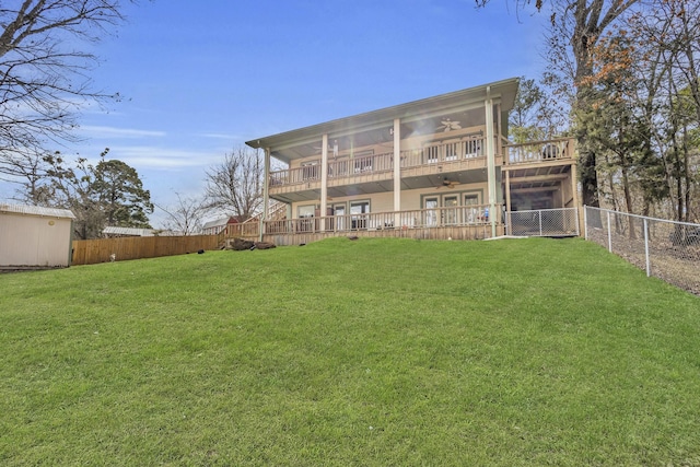 back of house with a wooden deck, a yard, a fenced backyard, and a ceiling fan