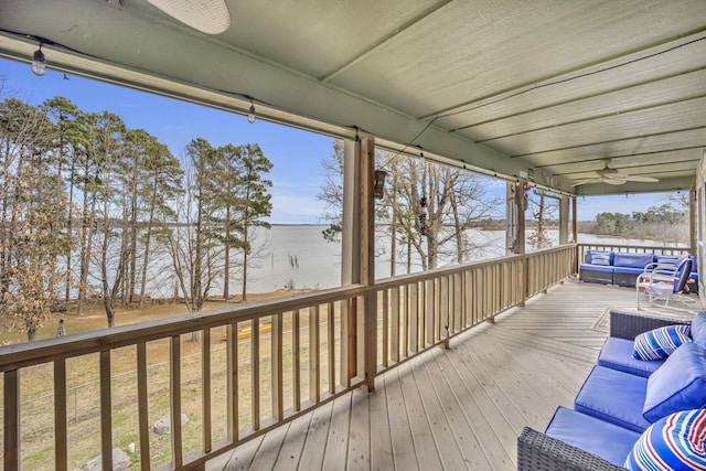 wooden deck featuring a ceiling fan, a water view, and an outdoor hangout area