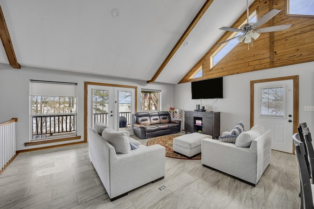 living area with plenty of natural light, french doors, and beamed ceiling