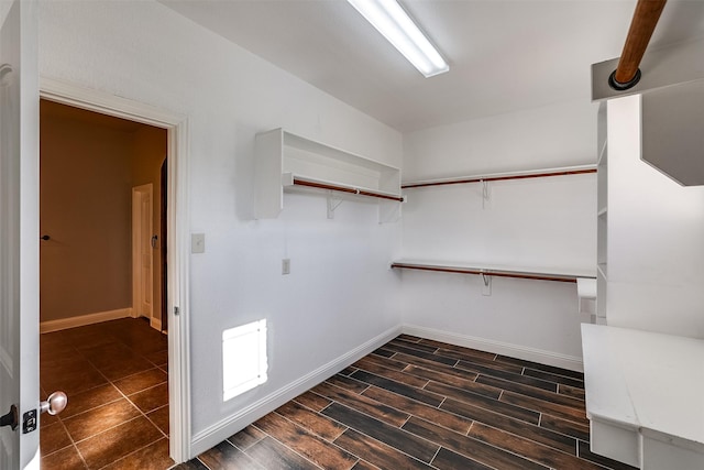 walk in closet with dark wood-style flooring and visible vents