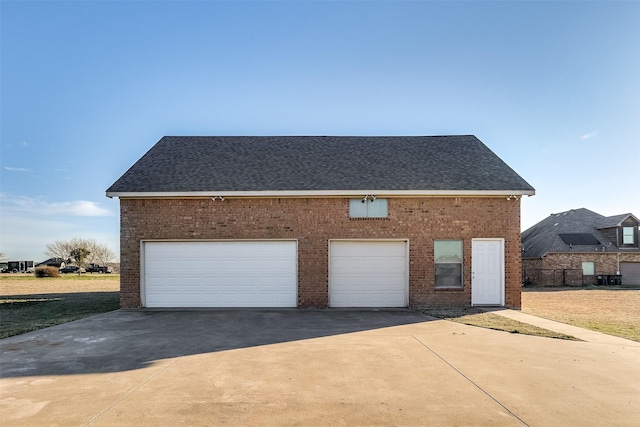 garage with concrete driveway