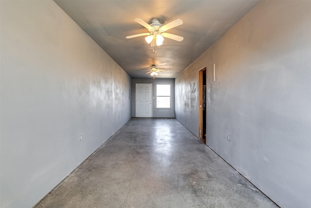 spare room featuring a ceiling fan and concrete floors