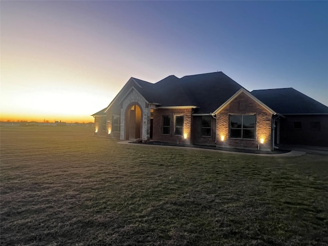 view of front of property with brick siding and a front yard