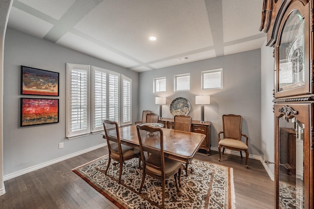 dining area featuring dark wood-style floors, baseboards, and visible vents