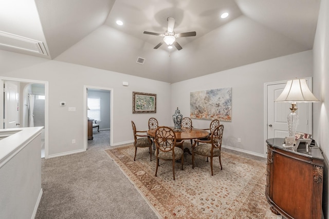 dining space with lofted ceiling, visible vents, light carpet, and baseboards