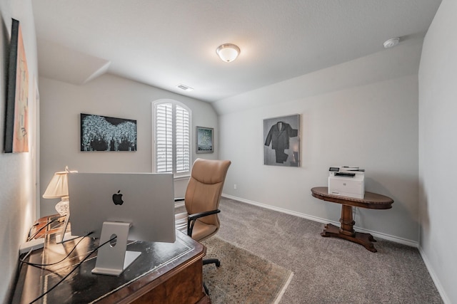 carpeted office featuring visible vents, vaulted ceiling, and baseboards