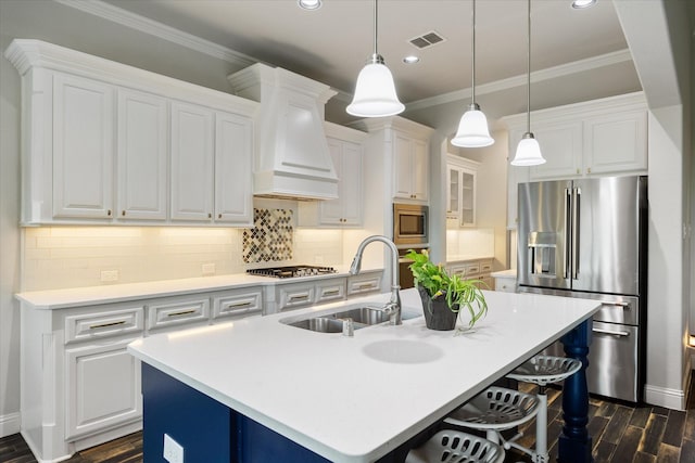 kitchen featuring dark wood finished floors, stainless steel appliances, custom range hood, visible vents, and a sink