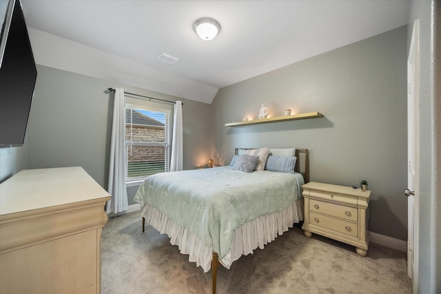 bedroom featuring light carpet, lofted ceiling, visible vents, and baseboards