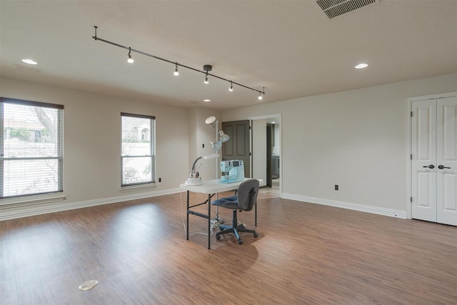 kitchen with open floor plan, visible vents, baseboards, and wood finished floors