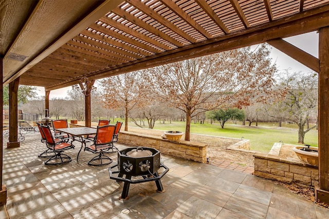 view of patio with outdoor dining area, a fire pit, and a pergola