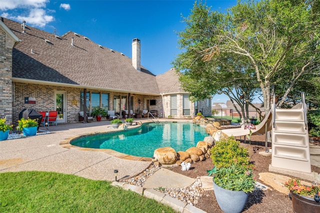 outdoor pool featuring a patio area and fence