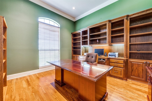 office space with light wood-type flooring, baseboards, and ornamental molding