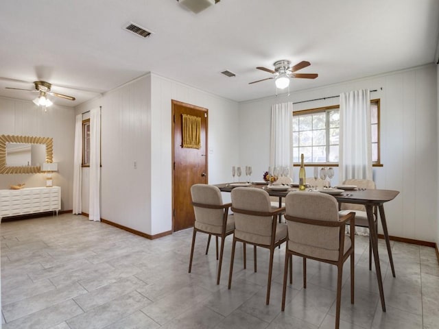 dining room with visible vents, baseboards, and ceiling fan