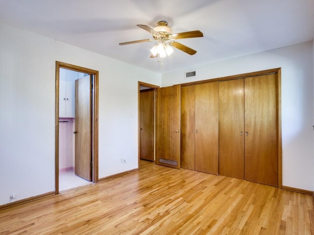 unfurnished bedroom with light wood-type flooring, visible vents, and baseboards