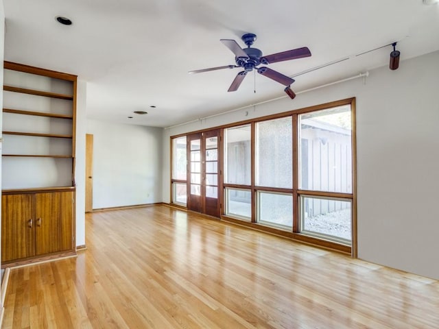 unfurnished living room with light wood-style floors and ceiling fan