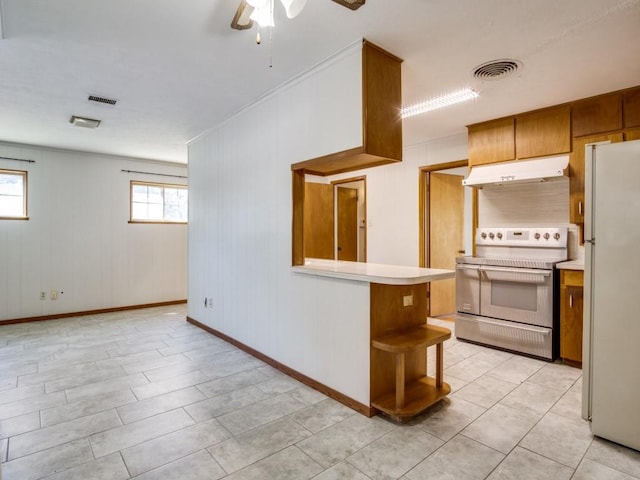 kitchen featuring light countertops, visible vents, freestanding refrigerator, under cabinet range hood, and stainless steel electric range