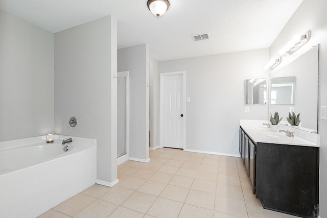 full bath featuring visible vents, a shower stall, a bath, tile patterned floors, and double vanity