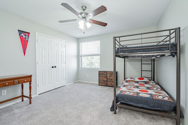 carpeted bedroom featuring ceiling fan and baseboards