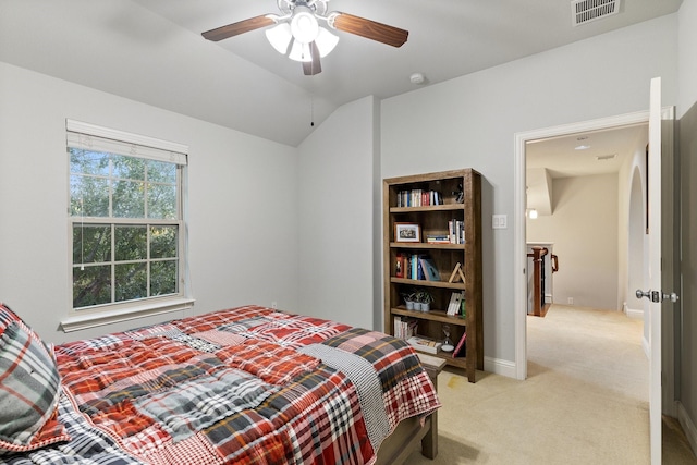 bedroom featuring lofted ceiling, light colored carpet, visible vents, ceiling fan, and baseboards