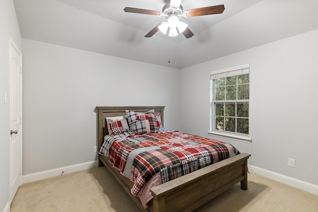 carpeted bedroom featuring a ceiling fan, vaulted ceiling, and baseboards