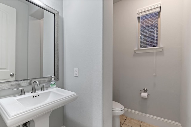 bathroom featuring tile patterned flooring, a sink, toilet, and baseboards