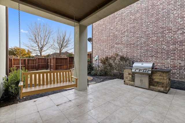 view of patio / terrace with a grill and fence