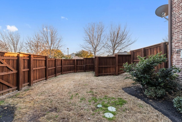 view of yard with a fenced backyard