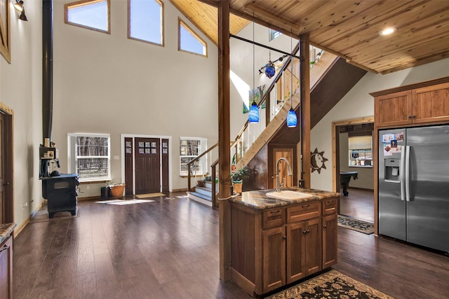 kitchen with wood ceiling, a healthy amount of sunlight, a sink, and stainless steel fridge with ice dispenser