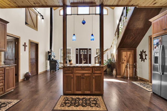 kitchen with wooden ceiling, dark wood-style floors, light stone counters, and stainless steel refrigerator with ice dispenser