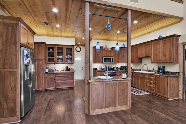 kitchen with stainless steel appliances, wood ceiling, visible vents, and a sink