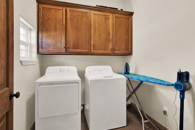 washroom with washing machine and dryer and cabinet space