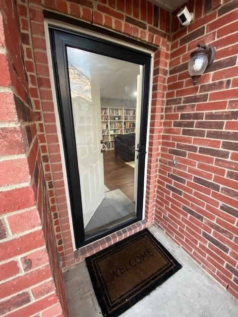 property entrance with brick siding