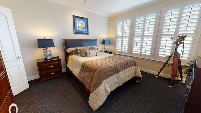 bedroom featuring baseboards, ornamental molding, and dark colored carpet