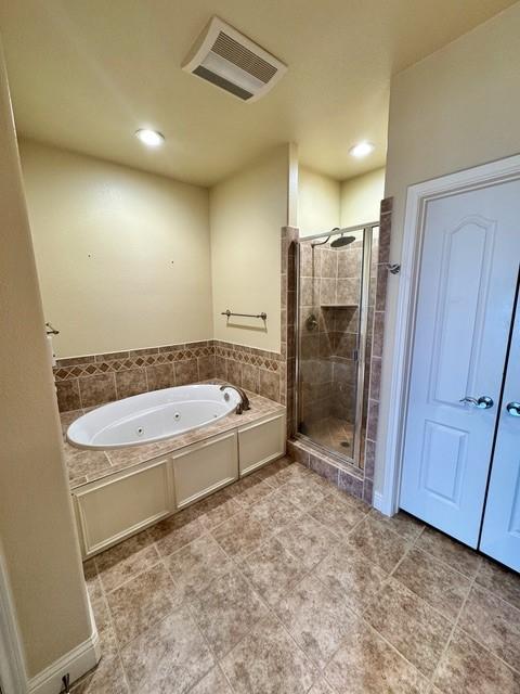 full bath featuring visible vents, a shower stall, and a tub with jets