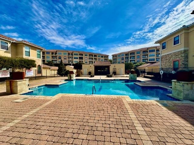 pool featuring a patio area and fence