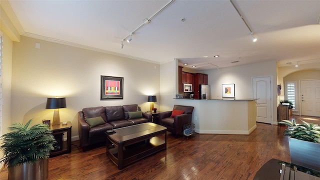 living area featuring arched walkways, rail lighting, crown molding, and wood finished floors