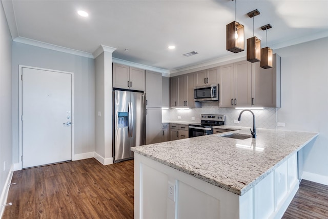 kitchen featuring a peninsula, a sink, stainless steel appliances, gray cabinetry, and backsplash