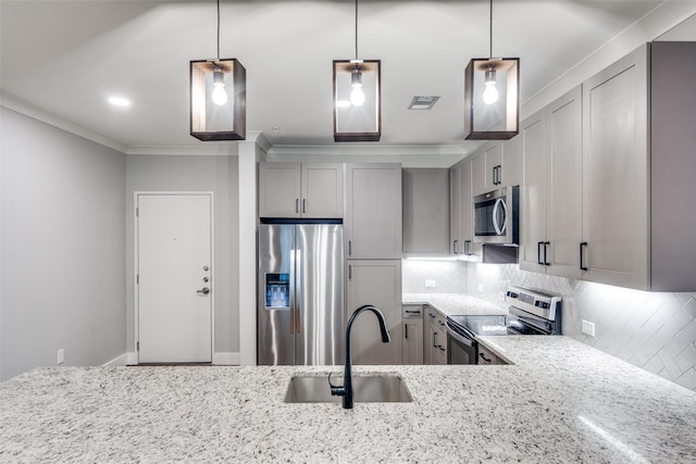 kitchen featuring stainless steel appliances, a sink, gray cabinetry, and light stone countertops