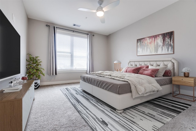 bedroom featuring baseboards, visible vents, a ceiling fan, light colored carpet, and vaulted ceiling