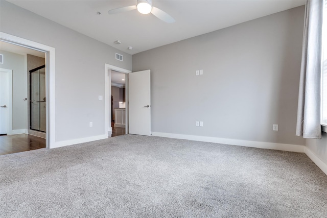 unfurnished bedroom featuring a ceiling fan, carpet, visible vents, and baseboards