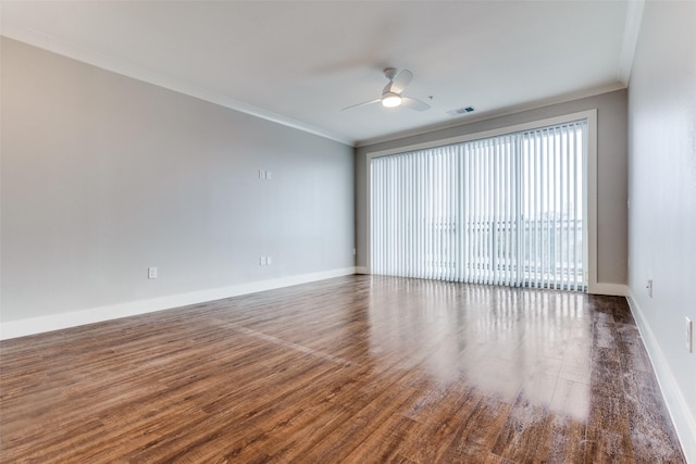 unfurnished room featuring crown molding, visible vents, ceiling fan, wood finished floors, and baseboards