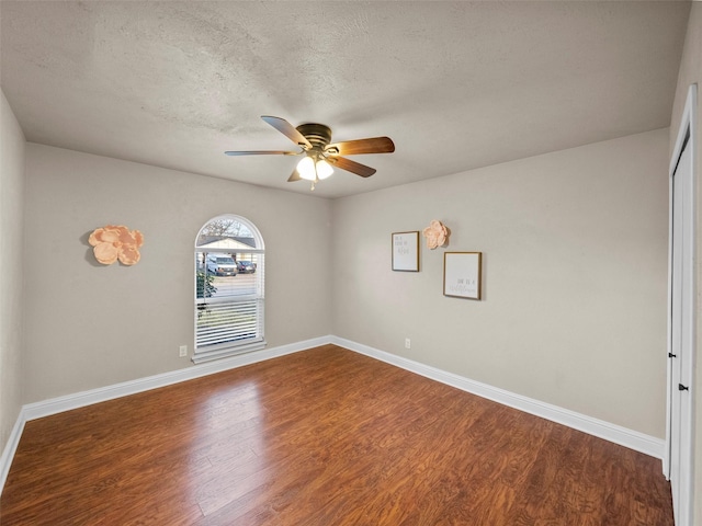 unfurnished room featuring a ceiling fan, a textured ceiling, baseboards, and wood finished floors