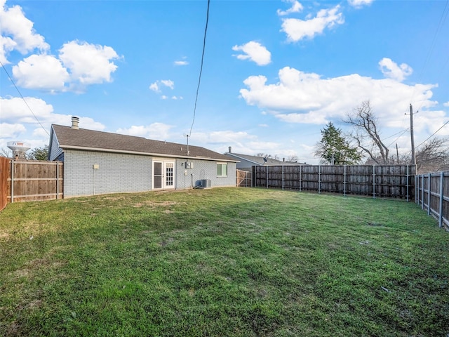 view of yard with cooling unit and a fenced backyard