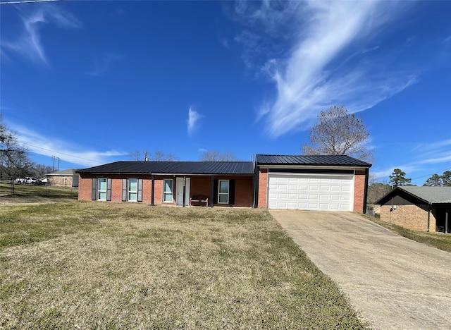 ranch-style house with a garage, metal roof, brick siding, and concrete driveway