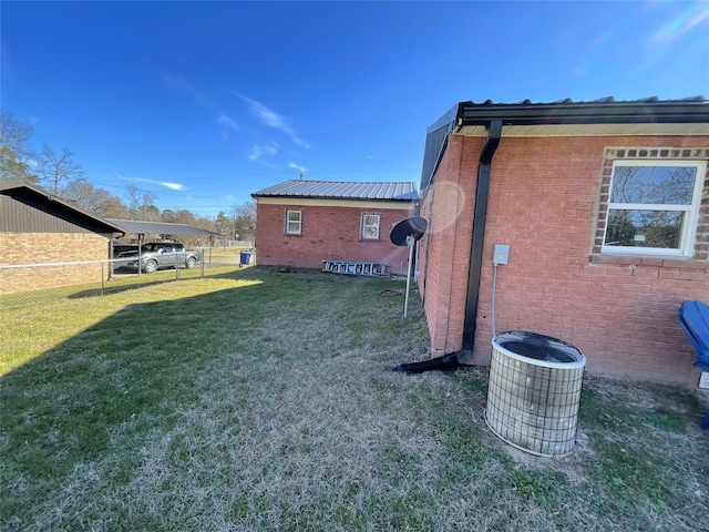 view of yard featuring fence and central AC unit