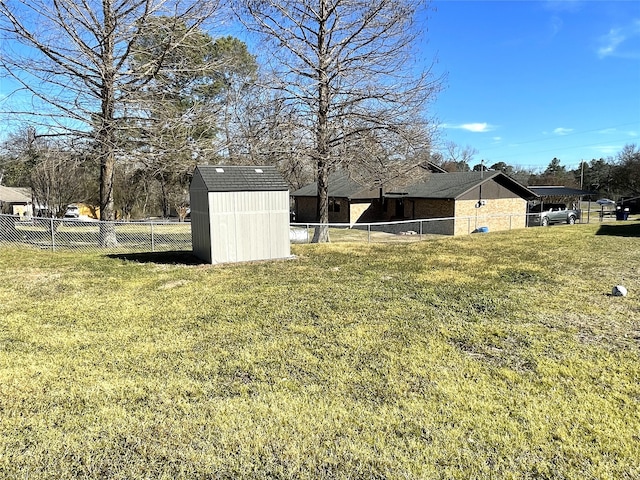 view of yard featuring an outbuilding, a shed, and a fenced backyard