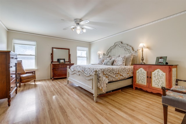 bedroom featuring baseboards, ornamental molding, a ceiling fan, and light wood-style floors