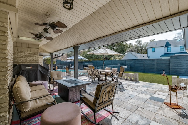 view of patio / terrace with outdoor dining space, a fenced backyard, ceiling fan, and area for grilling