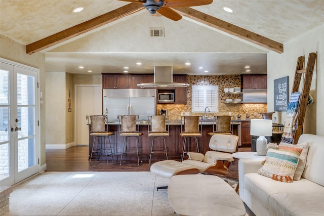 living room with french doors, beamed ceiling, and visible vents