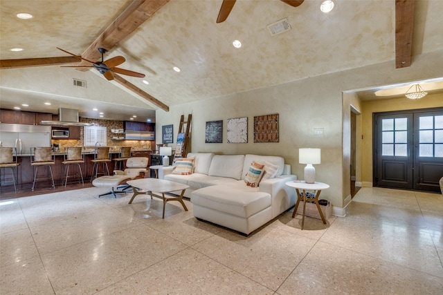 living area featuring light speckled floor, high vaulted ceiling, visible vents, baseboards, and beam ceiling